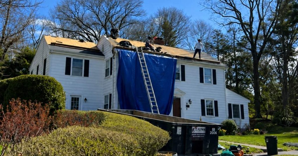 Asphalt shingle roof installation in progress on residential home