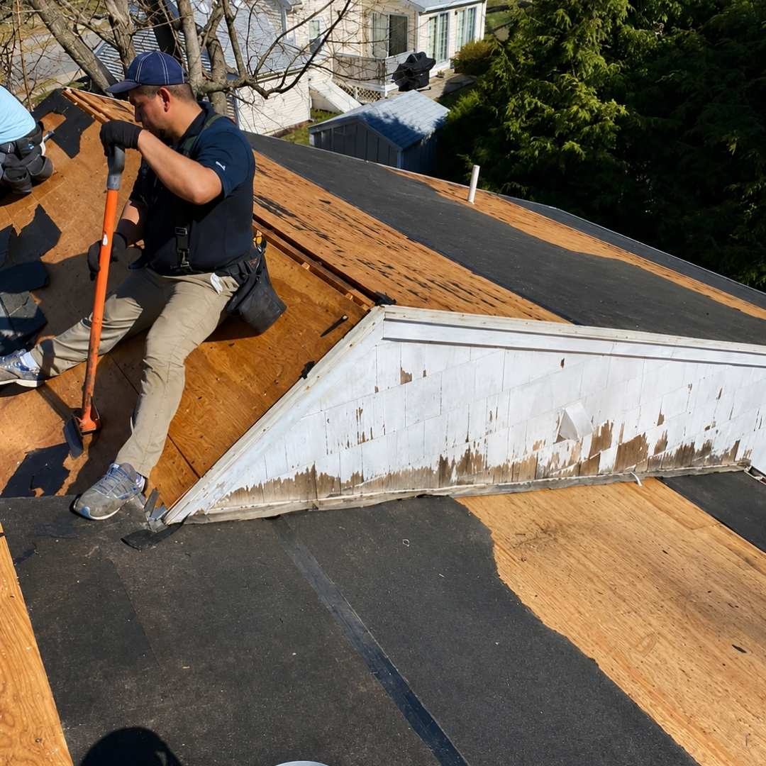 Existing roofing removed during asphalt shingle roof replacement on white house