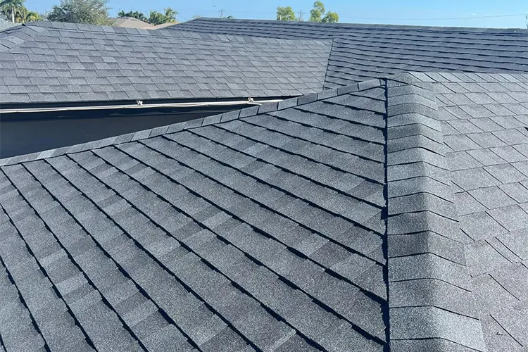 Close-up of durable dark grey asphalt shingles on a newly replaced residential roof
