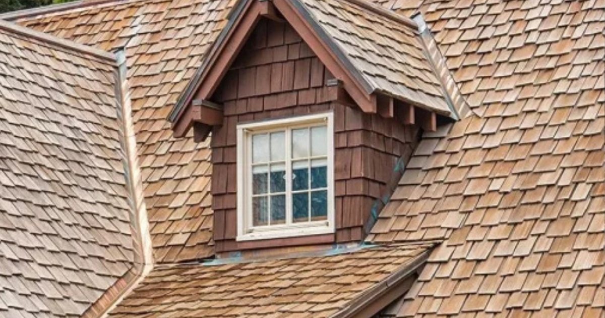 Cedar shingle roofing installed around dormers, valleys, hips, and detailed residential rooflines.