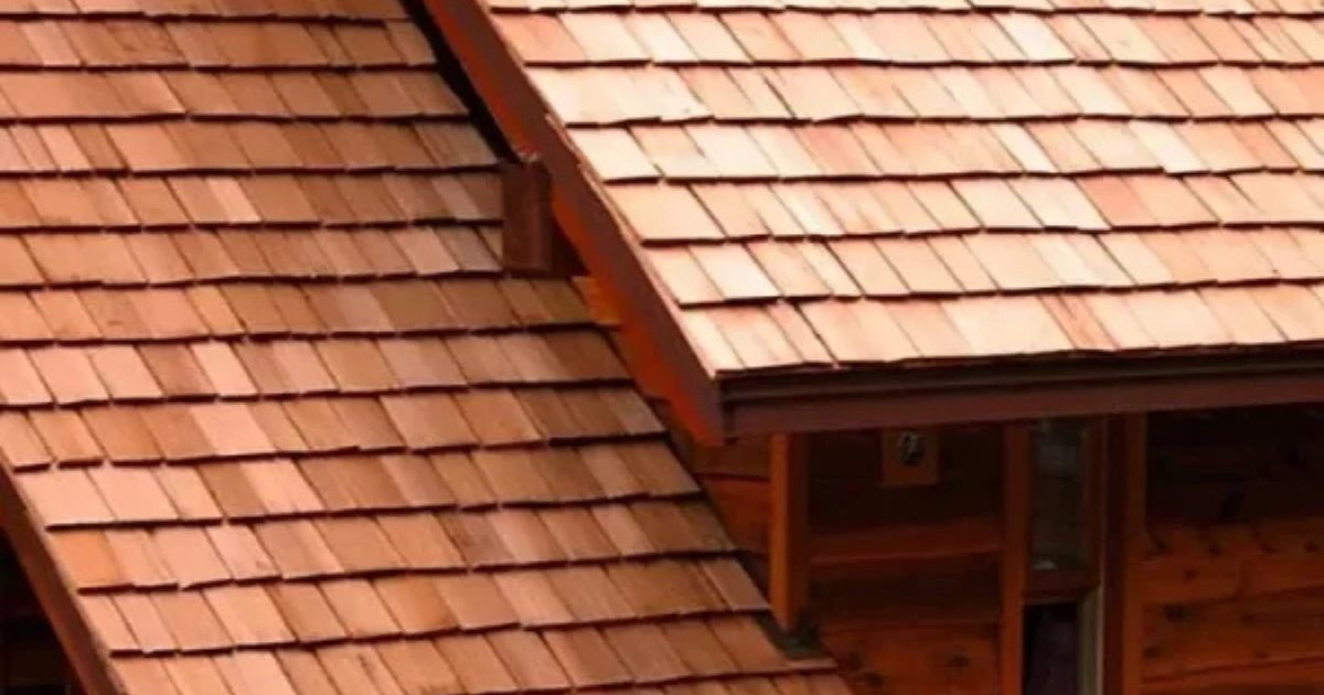 Detailed cedar roofing installation at a residential roof transition.