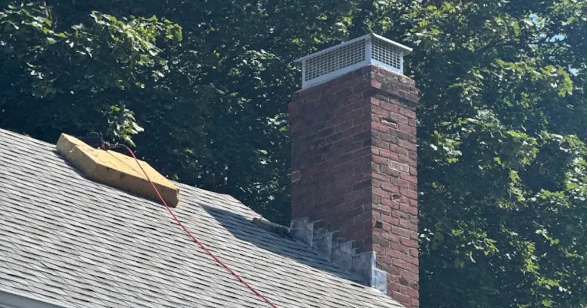 Roof flashing repair around a chimney completed by Clough Construction.