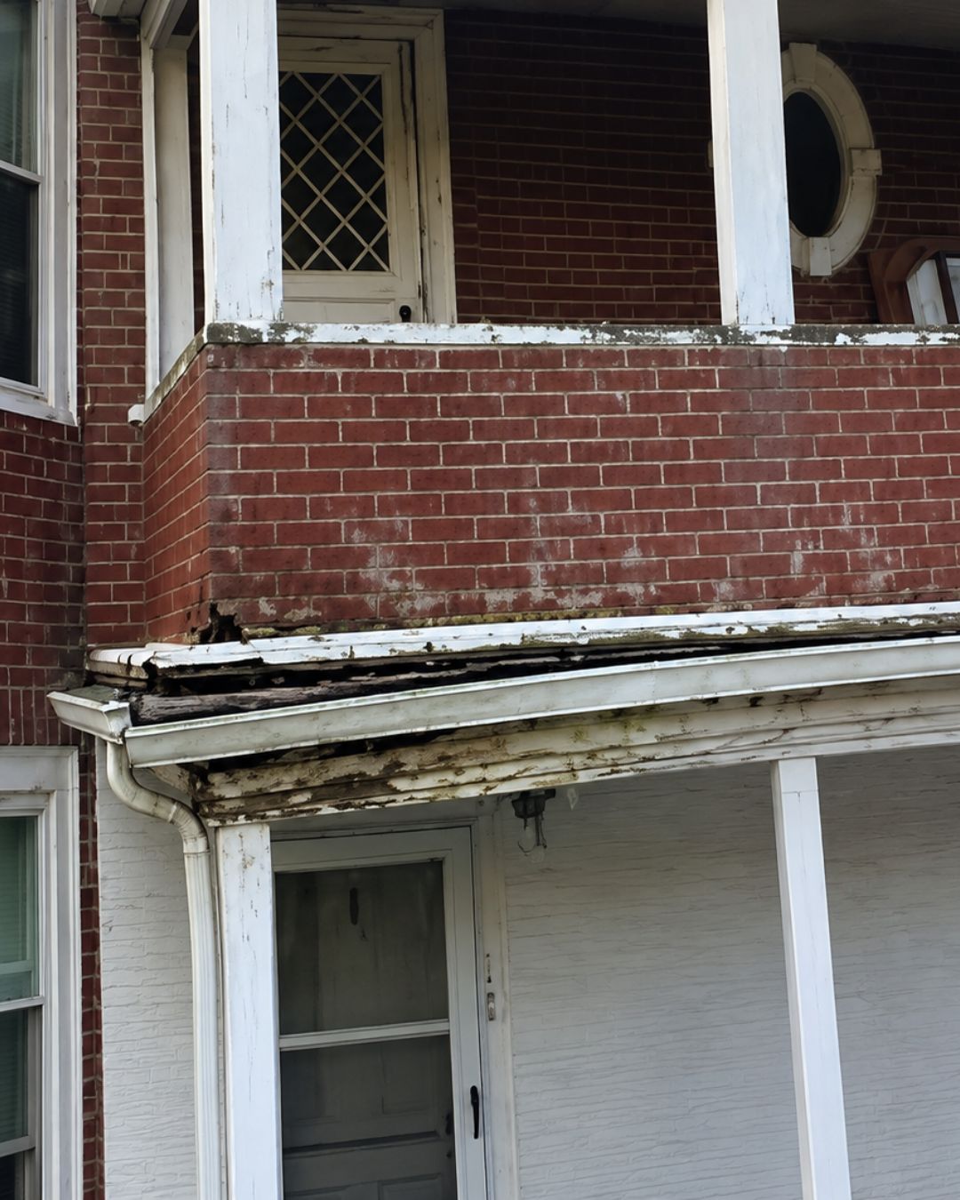 Professional inspection of damaged residential gutters on a Massachusetts home.