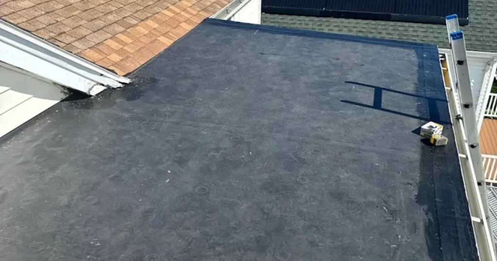 Completed EPDM rubber roofing system on a flat residential roof in Greater Boston, Massachusetts.