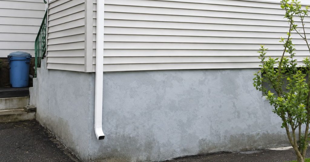 Residential downspout installed to direct roof runoff away from a Massachusetts home.