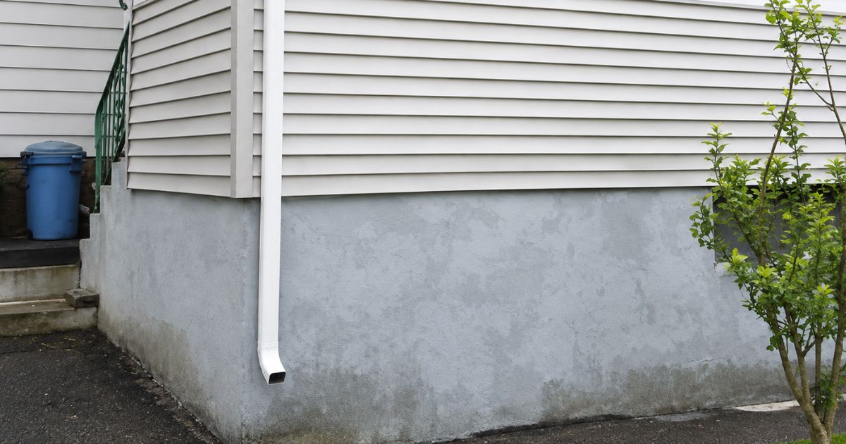Residential gutter downspout professionally installed on a Massachusetts home.