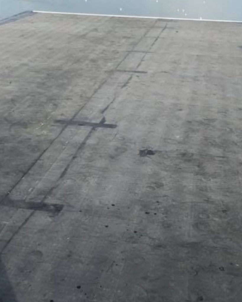 Installed EPDM rubber roofing system on waterfront low-slope roof