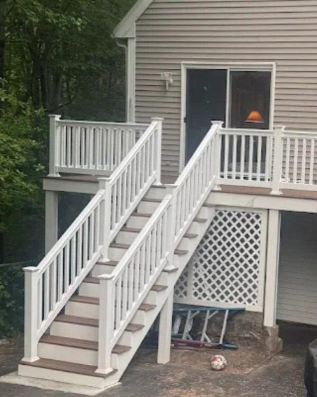 Completed new porch and exterior stairs with white railings