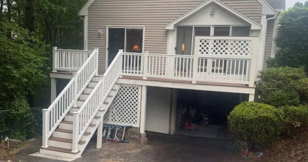 Completed new porch and exterior stairs with white railings