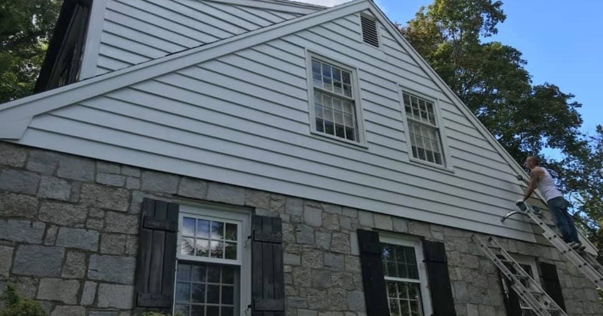 Professional siding installation on a residential home in Massachusetts.