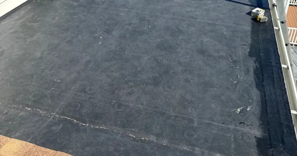 Completed EPDM rubber roofing system on a residential flat roof in Massachusetts.