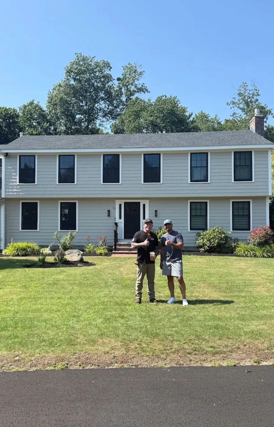 Robert Clough meeting with homeowners after completing a residential roofing project in North Reading, Massachusetts.
