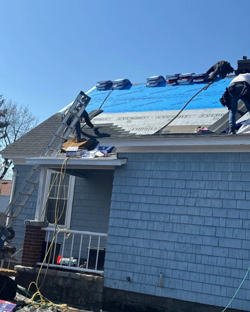 Professional roof inspection identifying damaged shingles and flashing on a Massachusetts home.