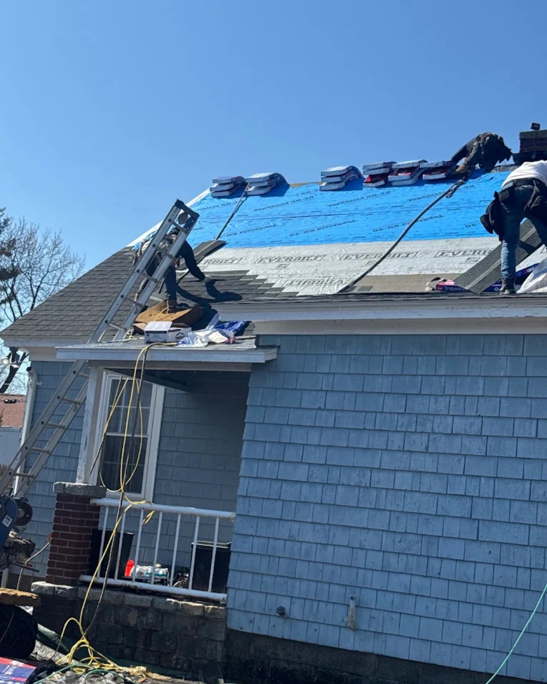 Professional roof inspection identifying damaged shingles and flashing on a Massachusetts home.