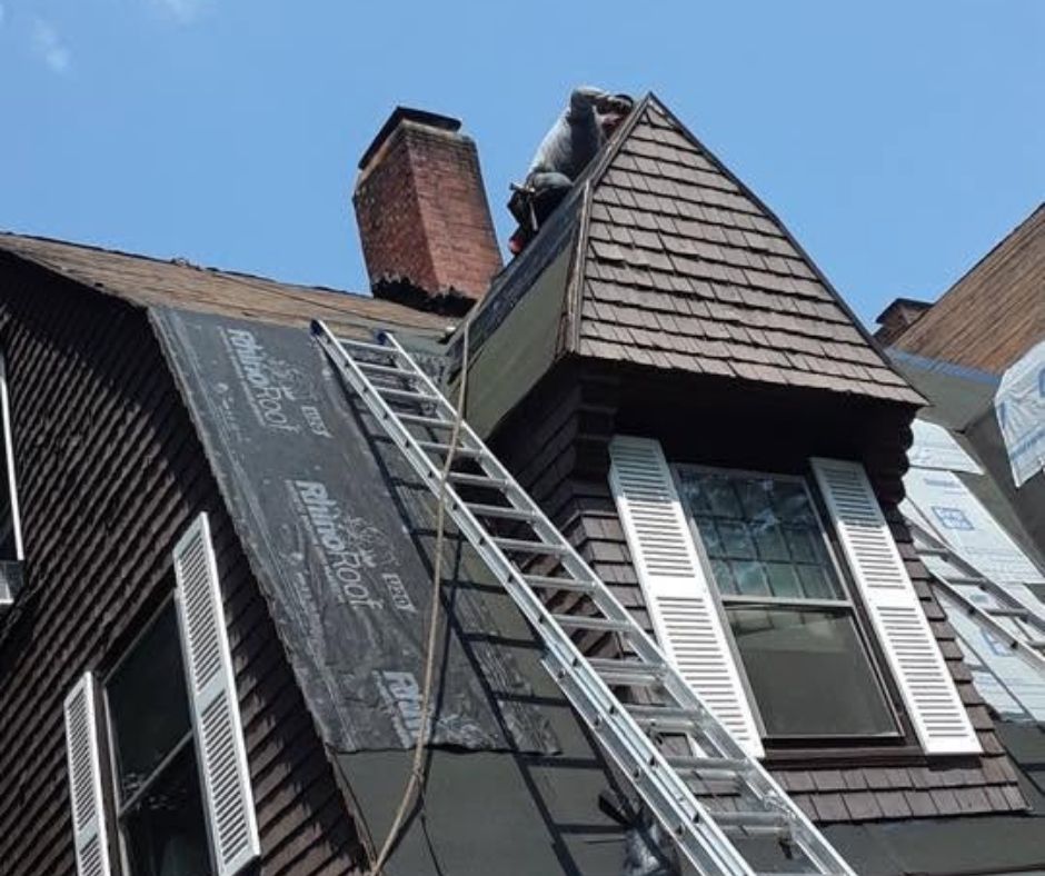 Roof underlayment installation around dormer during asphalt roof replacement