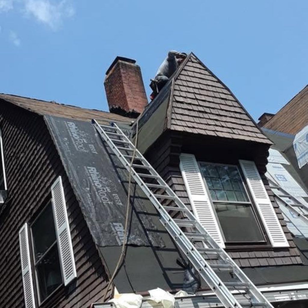 Roof underlayment installation around dormer during asphalt roof replacement