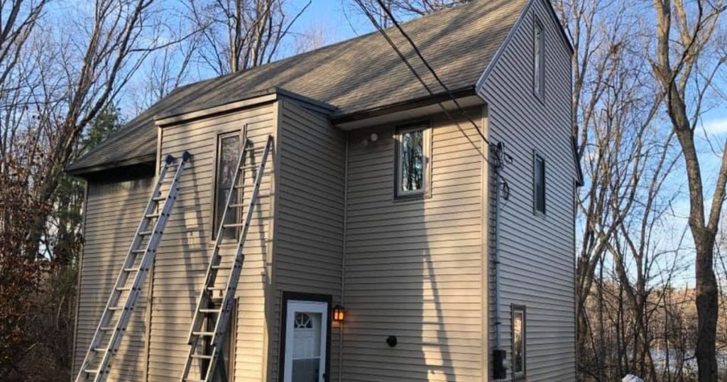 Final walkthrough after residential siding installation completed by Clough Construction.