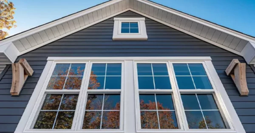 Completed siding and window installation by Clough Construction on a Massachusetts home.