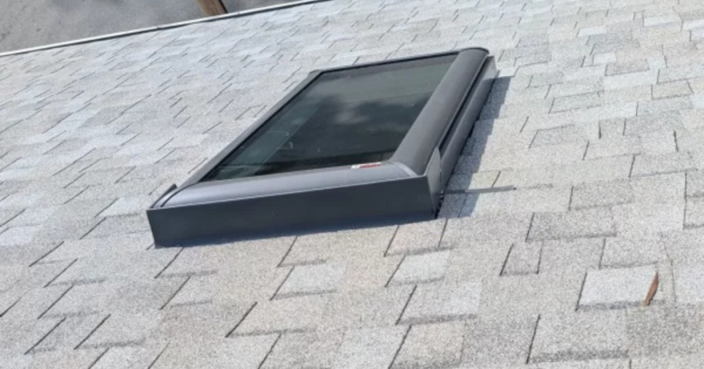 New skylight installation completed on an asphalt shingle roof by Clough Construction.