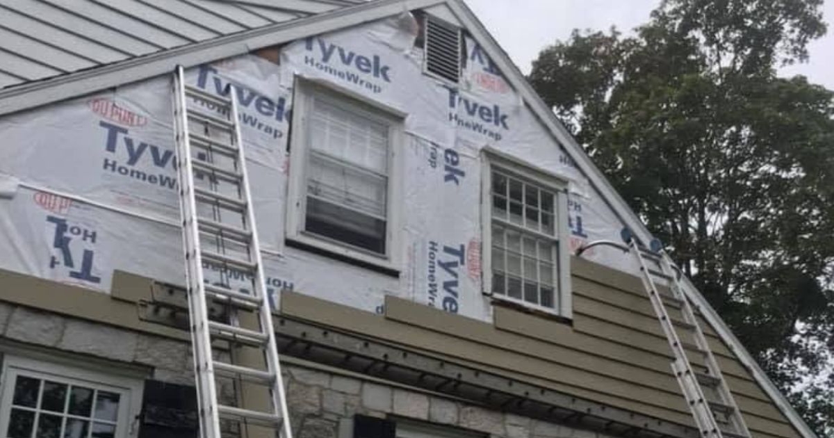 Weatherproof flashing installed around a residential window opening in Massachusetts.