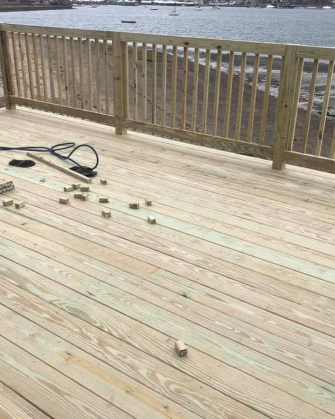 New wood deck and railing overlooking waterfront